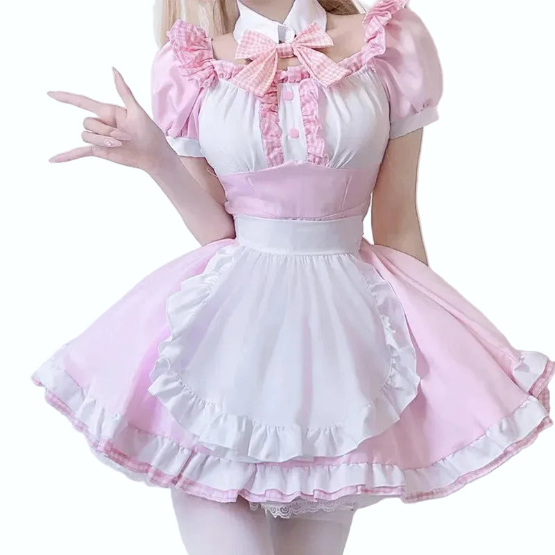 Woman wearing a pink and white dress with ruffled details on a plain background