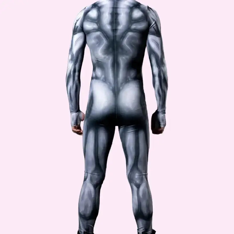 Person wearing a full-body suit with geometric pattern on a dark background