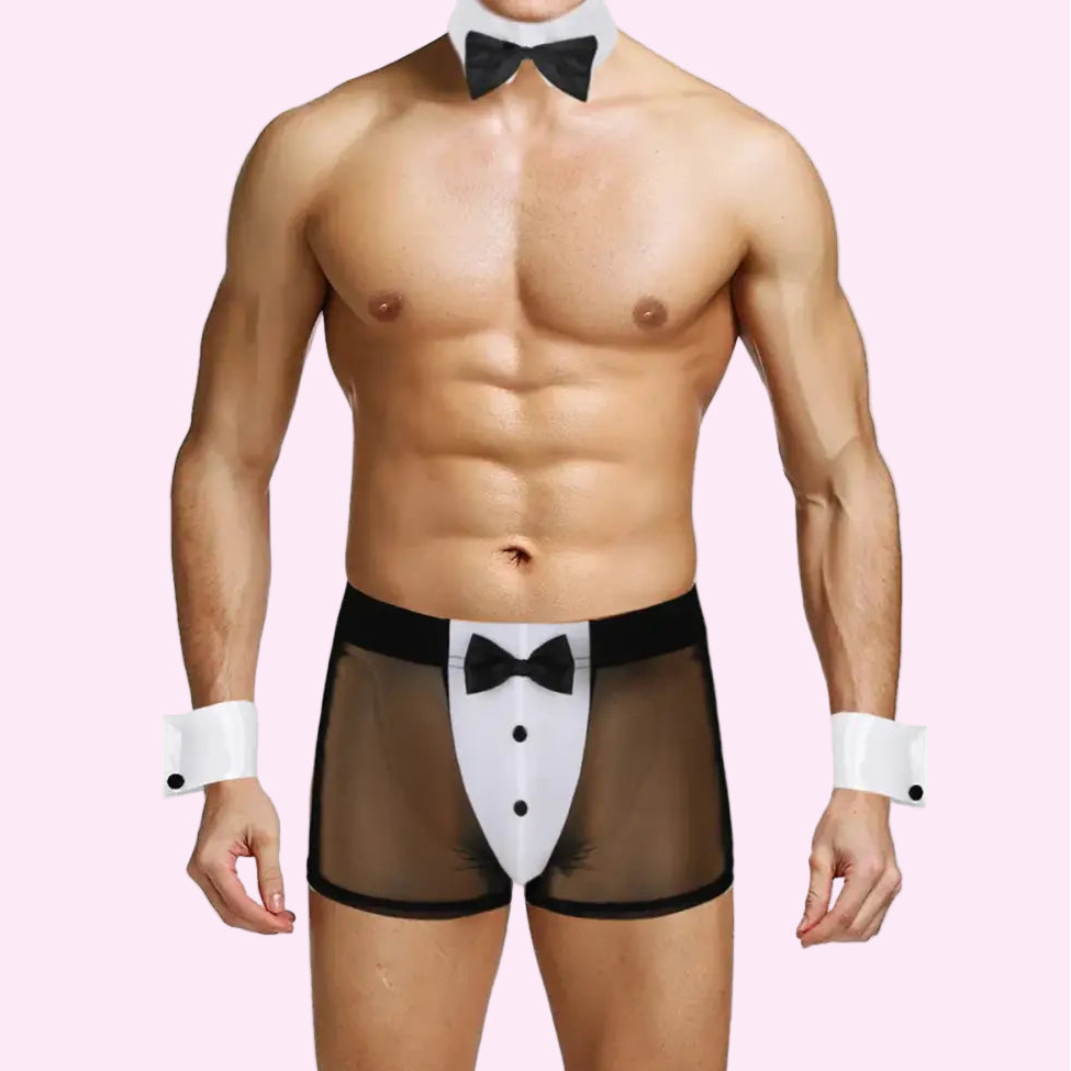 Man wearing a tuxedo-themed underwear set with bow ties on a pink background