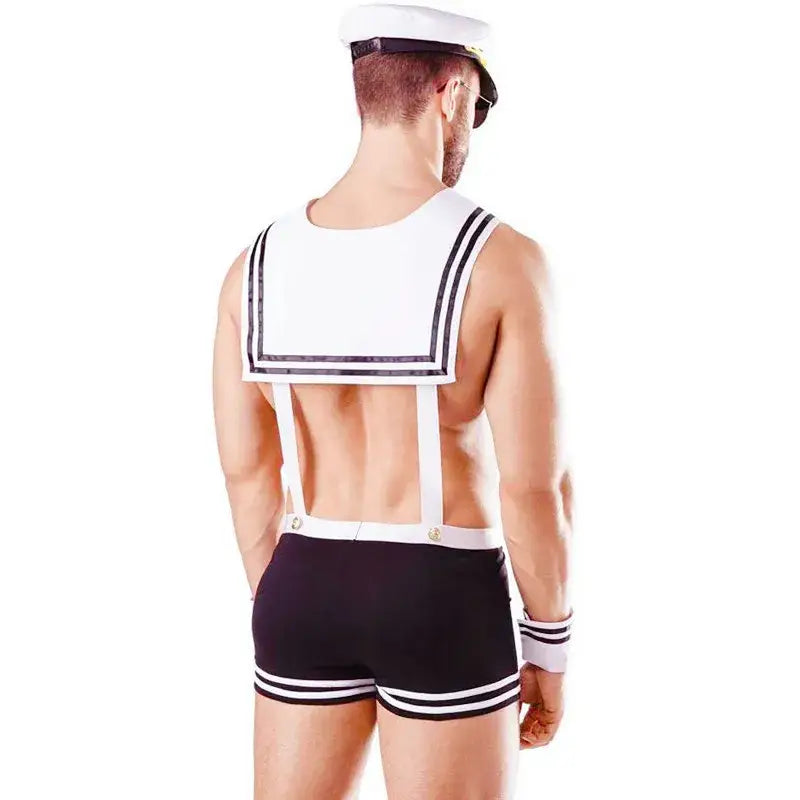 Man wearing a sailor outfit with a white shirt, black shorts, and a cap on a white background