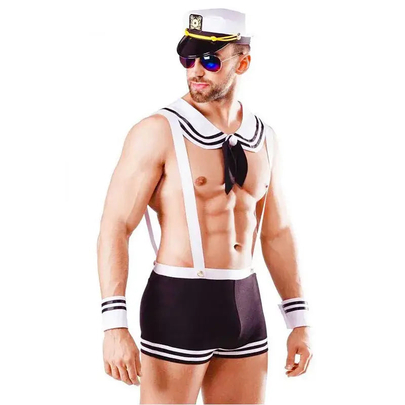 Man wearing a sailor-themed costume with suspenders and a hat on a white background