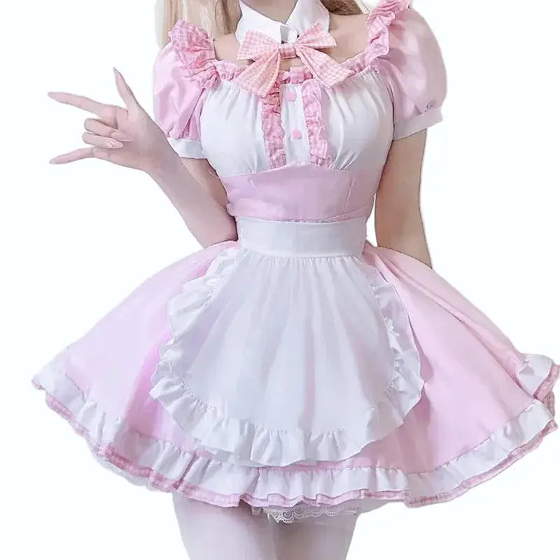 Woman wearing a pink and white dress with ruffled details on a plain background