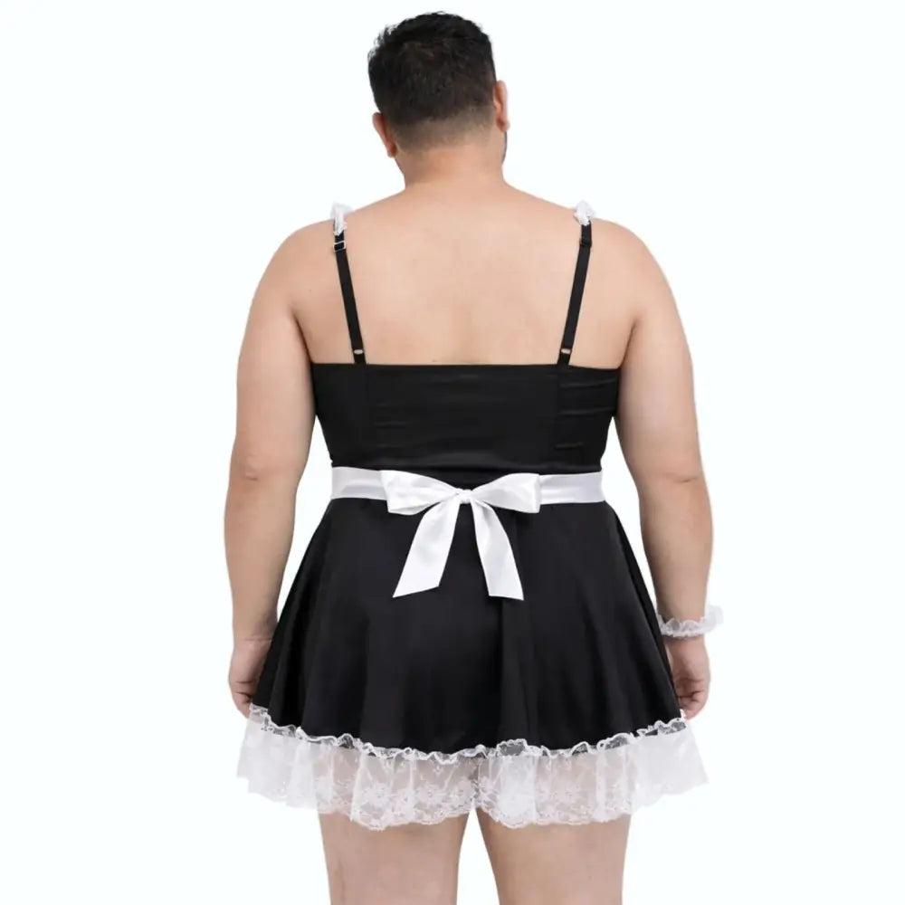 Man wearing a black dress with white lace trim and a white bow on a white background