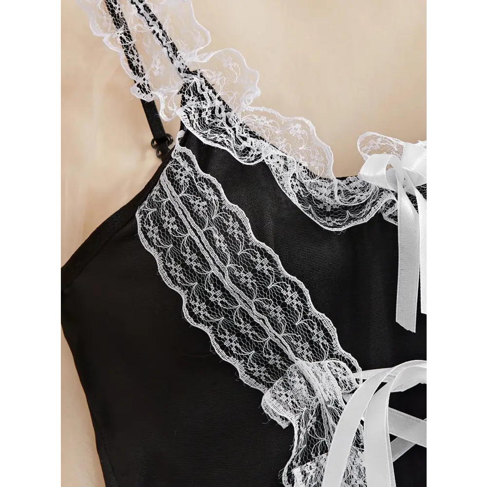 Black lace-trimmed top  for men with white ribbons on a beige background