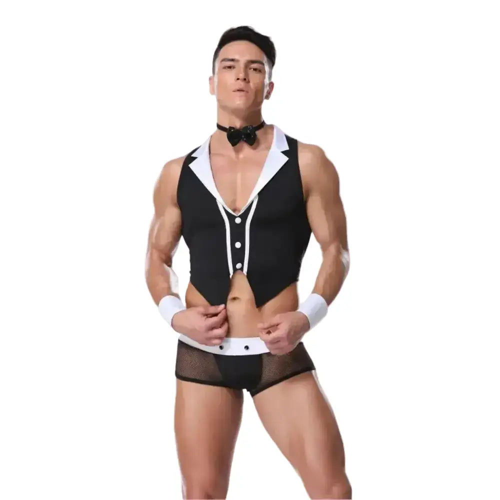 Man wearing a black and white tuxedo-style romper on a pink background