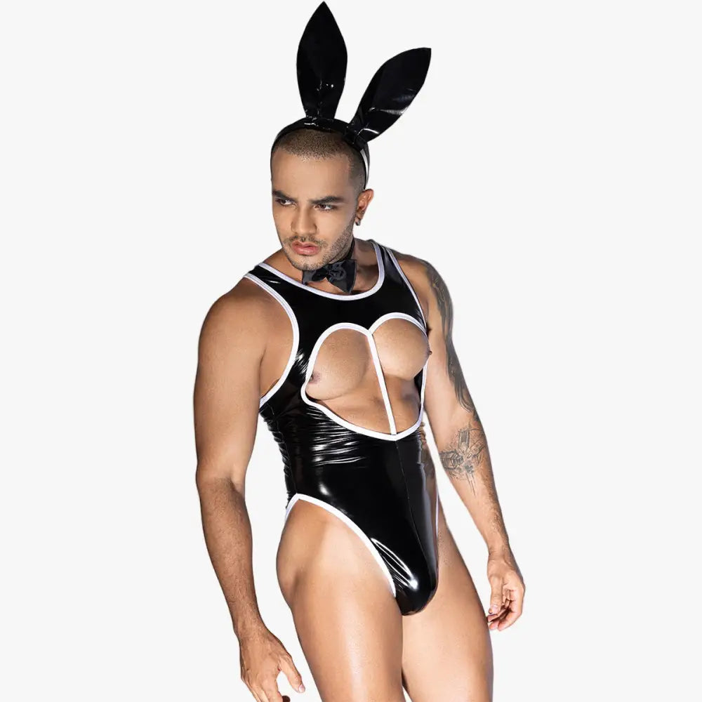 Person wearing a black latex outfit with cut-out design and bunny ears on a white background