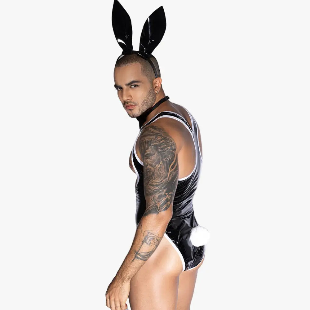 Person wearing a black rubber bunny costume with rabbit ears on a white background