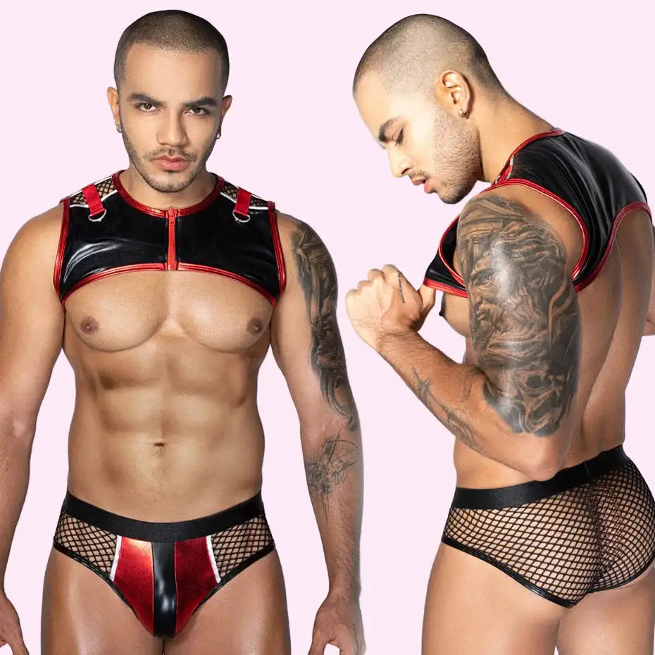 Man wearing a black and red leather outfit with fishnet stockings on a white background